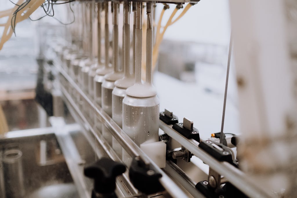 Close-up of automated canning equipment in a brewery, highlighting the manufacturing process.